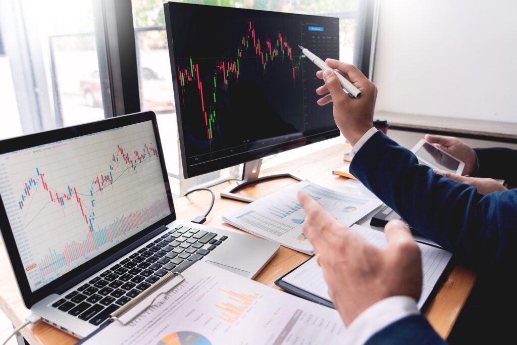 Traders analyzing stock market charts and analyst research data