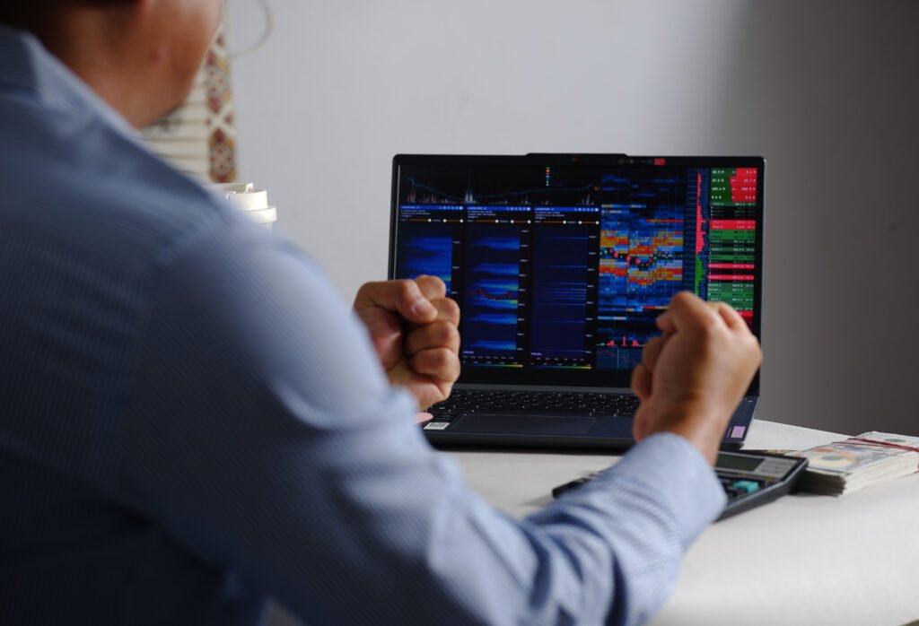 Trader analyzing pre-market stock charts on a laptop
