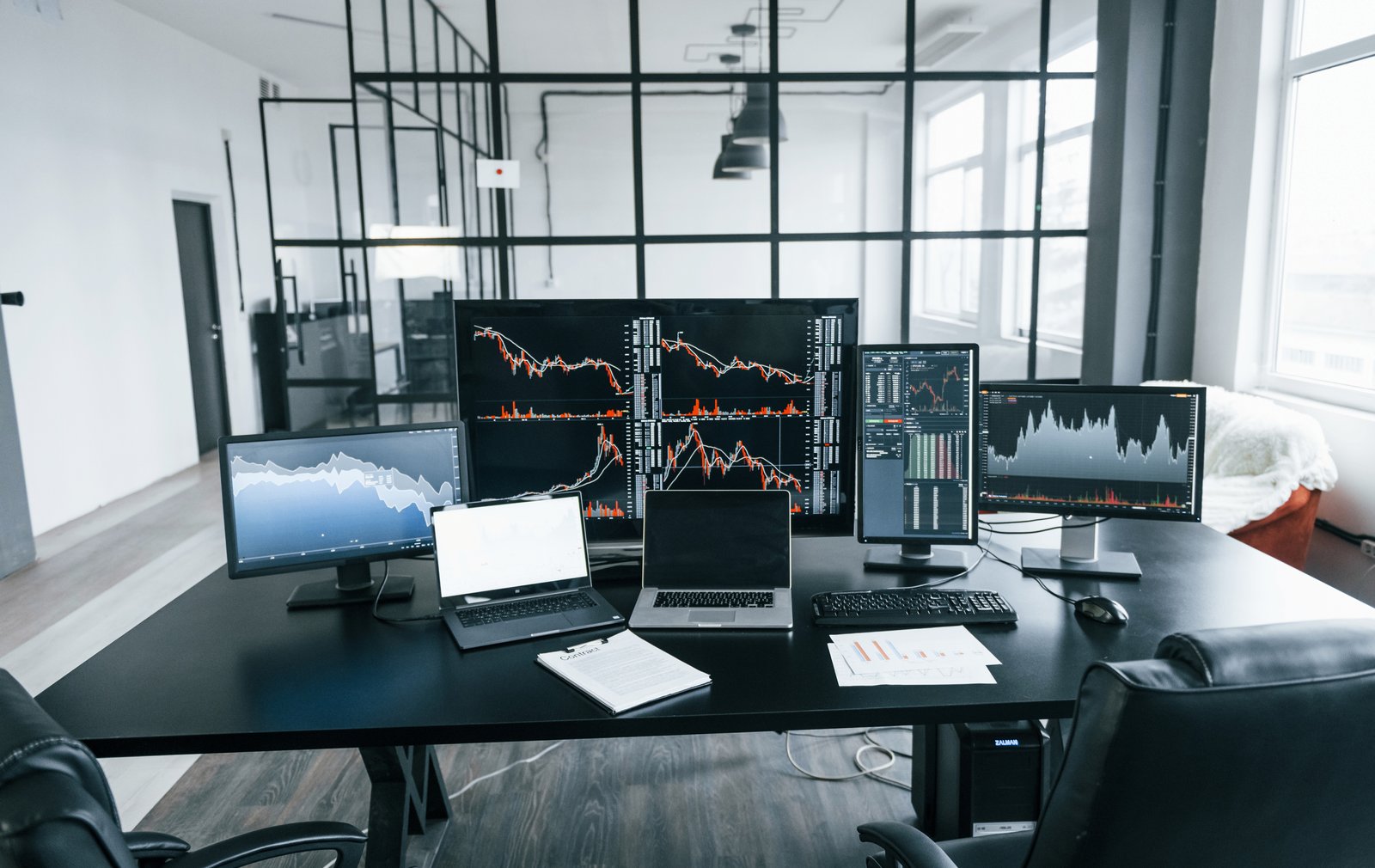 Multiple monitors showing stock charts in a home trading setup