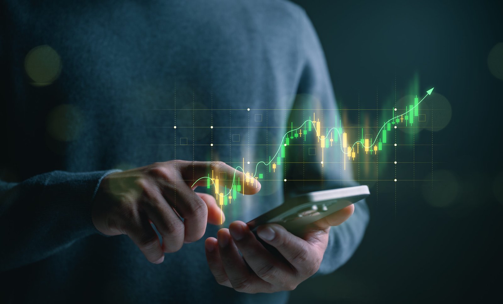 Trader using a stock grading system on smartphone to make a final decision